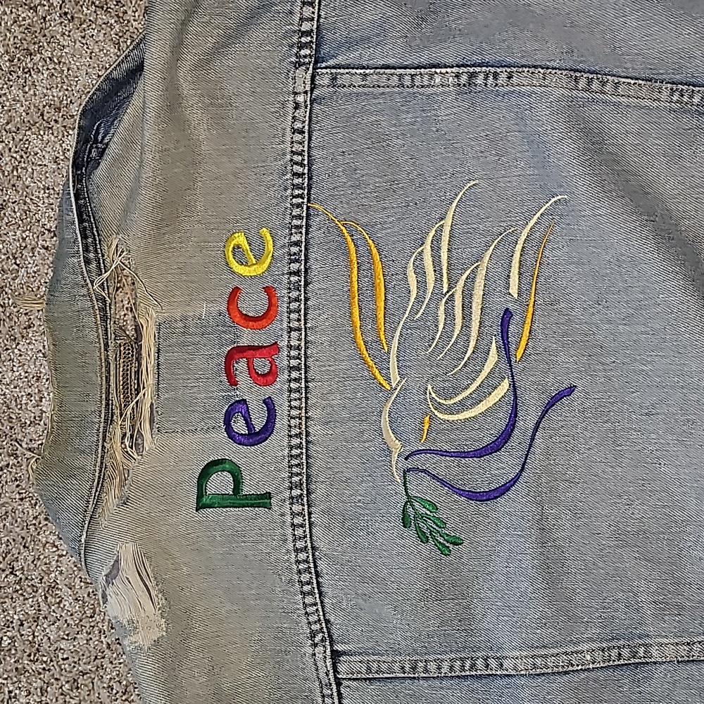 A '90s era size extra large Levi trucker denim jacket with custom embroidery